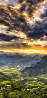 Breathtaking mountain sunset with lush valley and vibrant sky scenery.