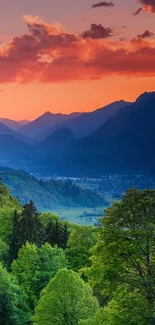 Vibrant sunset over mountain landscape with lush green forest.