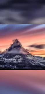 Mountain peak at sunset with colorful sky hues.