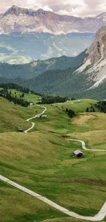 Scenic view of green valleys and rocky mountain peaks in a serene landscape.