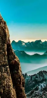 Majestic mountain view with blue sky and rocky cliffs at sunrise.