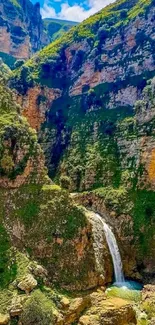 Lush green mountain landscape with waterfall.