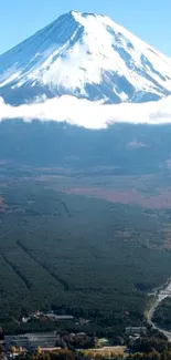 Majestic Mount Fuji with clear blue sky and scenic landscape on mobile wallpaper.