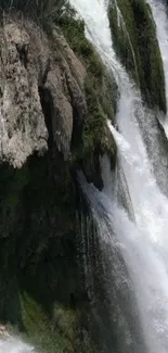 Cascading waterfall with lush green surroundings, perfect for mobile wallpaper.