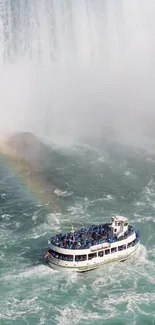 Niagara Falls with rainbow and boat in scenic view.