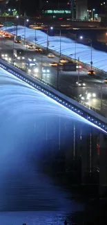 Illuminated bridge with waterfall effect at night, showcasing vibrant blue lights.