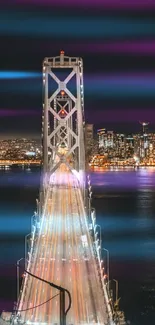 City bridge illuminated at night with vibrant skyline and lights.