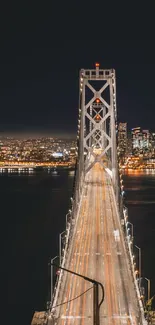 A picturesque city bridge lit up at night with vibrant urban lights.