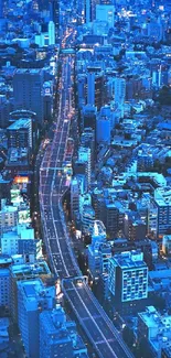 A breathtaking aerial view of a vibrant city at night with glowing blue lights.