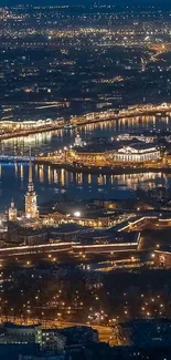 Aerial view of illuminated cityscape at night with stunning light reflections.