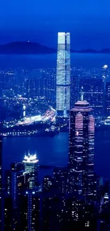 A vibrant night cityscape with illuminated skyscrapers against a dark blue sky.