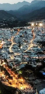 Aerial view of a vibrant night cityscape with glowing street lights.