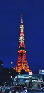 Tower illuminated in city at night with glowing lights.