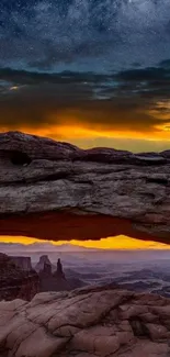 Starry night over a canyon with vibrant sunset and rocky formations.