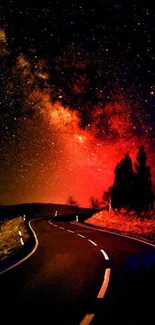 Curved road under a stunning red starry night sky.