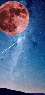 Night sky with red moon and shooting star over a starry blue background.