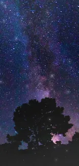 A breathtaking wallpaper of a starry night sky with galaxy and tree silhouettes.