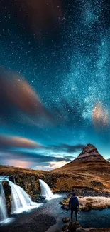 Night sky with stars, waterfall, and mountain landscape.