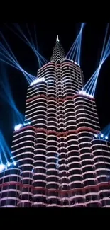 Spectacular night view of illuminated tower with blue light beams.