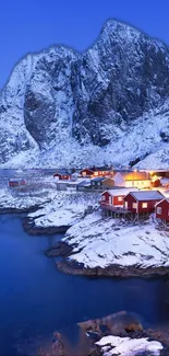 Nordic village with snow-covered mountains and blue waters in stunning winter view.