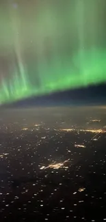 Aerial view of the Northern Lights over a city at night.