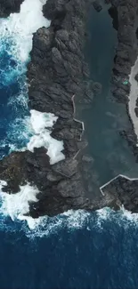 Aerial view of ocean cliffs and waves crashing on rocks.