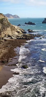 Ocean waves crashing against the cliffside beach with a stunning coastal view.