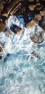 Aerial view of ocean waves crashing over rocks in stunning mobile wallpaper.