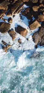 Ocean waves crashing against rocky shore wallpaper.