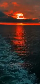 Orange sunset over ocean with reflecting waters.