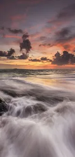 Beautiful ocean sunset with colorful sky and waves crashing on rocks.