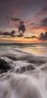 Breathtaking sunset over ocean with crashing waves and colorful sky.