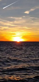 Vibrant sunset over ocean with meteor streak in colorful evening sky.