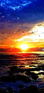 Colorful sunset with birds flying over ocean.