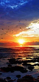 Vibrant ocean sunset with birds flying in a colorful sky.