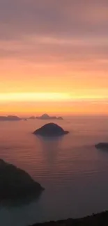 A vibrant sunset over the ocean with islands in silhouette.