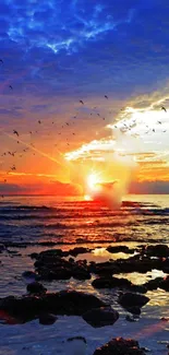 Vibrant sunset over ocean with birds and waves.