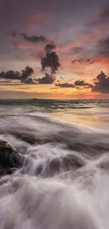 Ocean sunset with waves crashing under a colorful sky.