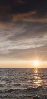 A stunning sunset over the ocean with waves and a colorful sky.