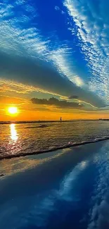 Vibrant ocean sunset with beach reflection and blue sky.