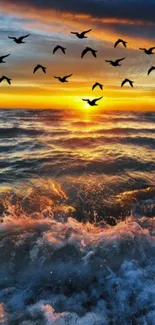 Ocean sunset with birds flying, waves crashing and vibrant orange sky.