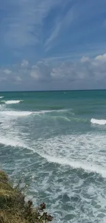 Breathtaking ocean view with waves and a clear blue sky.