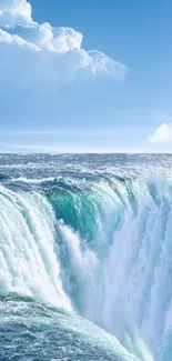 Serene ocean waterfall with blue sky and clouds wallpaper.