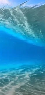 Underwater view of a vibrant blue ocean wave, showcasing natural beauty.