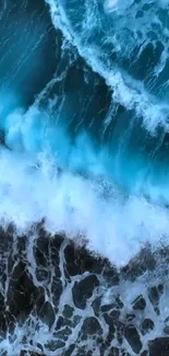 A mesmerizing blue ocean wave crashing against the shore, captured from above.
