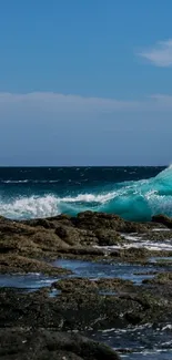 Vibrant turquoise ocean wave crashing on rocky shore.