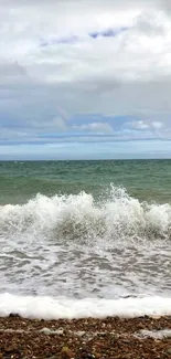 Mobile wallpaper with ocean waves and dramatic clouds.