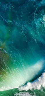 Aerial view of vibrant ocean waves in blue and green hues.