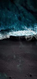 Dark cyan ocean waves breaking on a beach, captured in stunning detail.