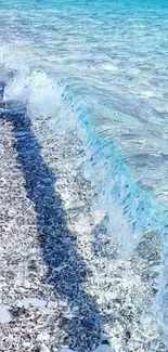 Beautiful ocean waves crashing on a white sandy beach, under a clear blue sky.